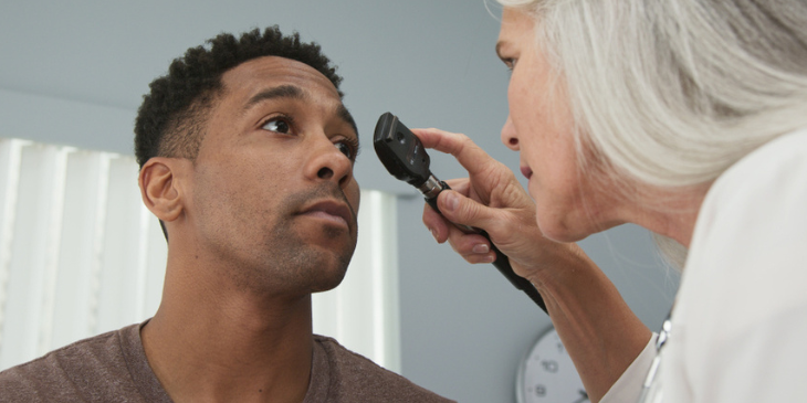 friendly-eye-doctor-examines-man-s-eyes-685345