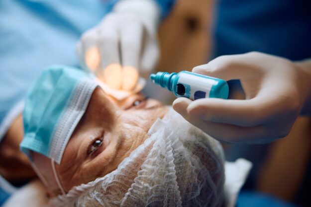 Close up of ophthalmologist giving her patient anesthetic drops before eye surgery. Close up of ophthalmologist giving her patient anesthetic drops before eye surgery.